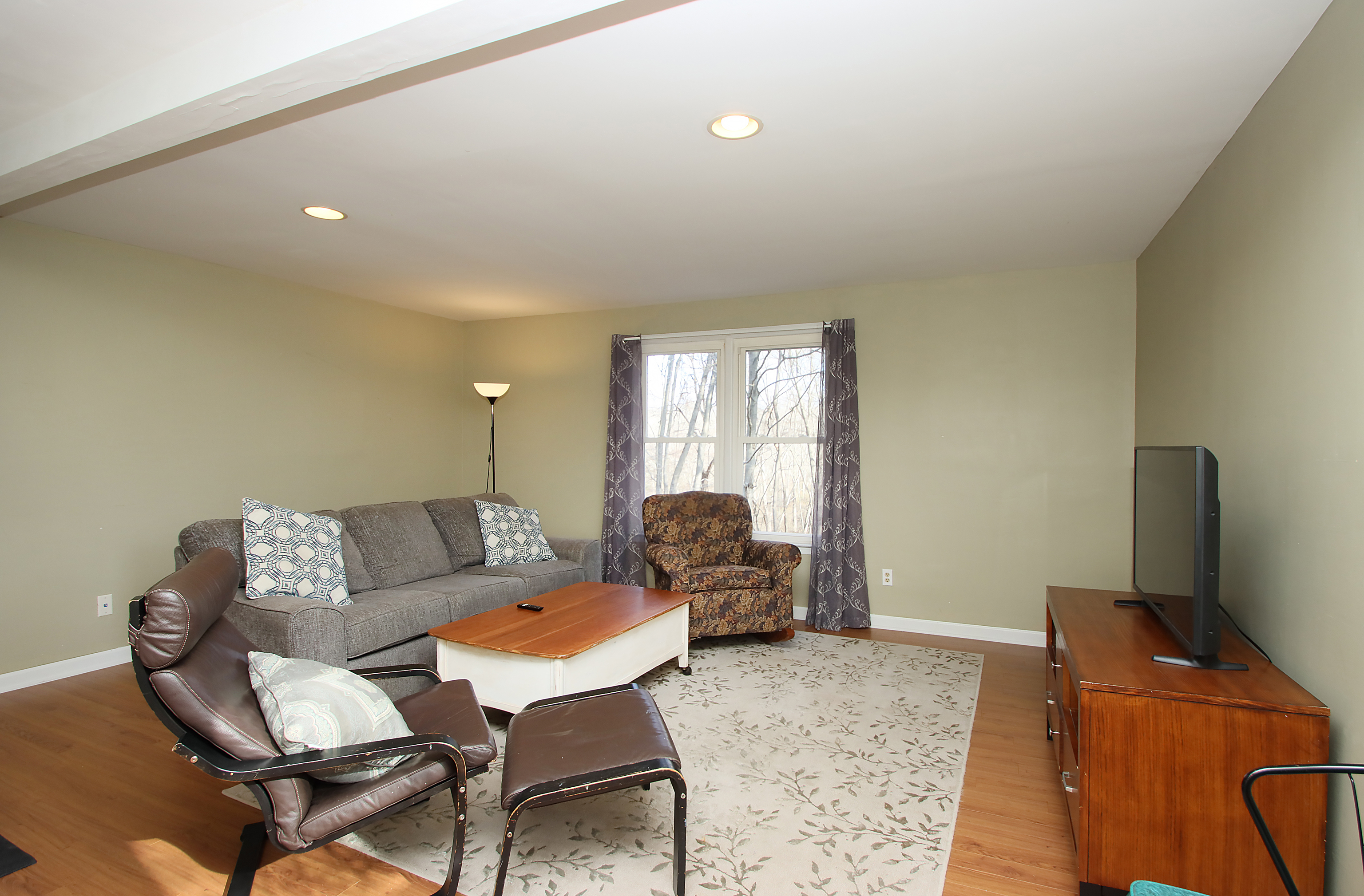 20 Carriage Drive Clinton, CT 06413 - Photo 20 of 31 a living room with furniture and a flat screen tv