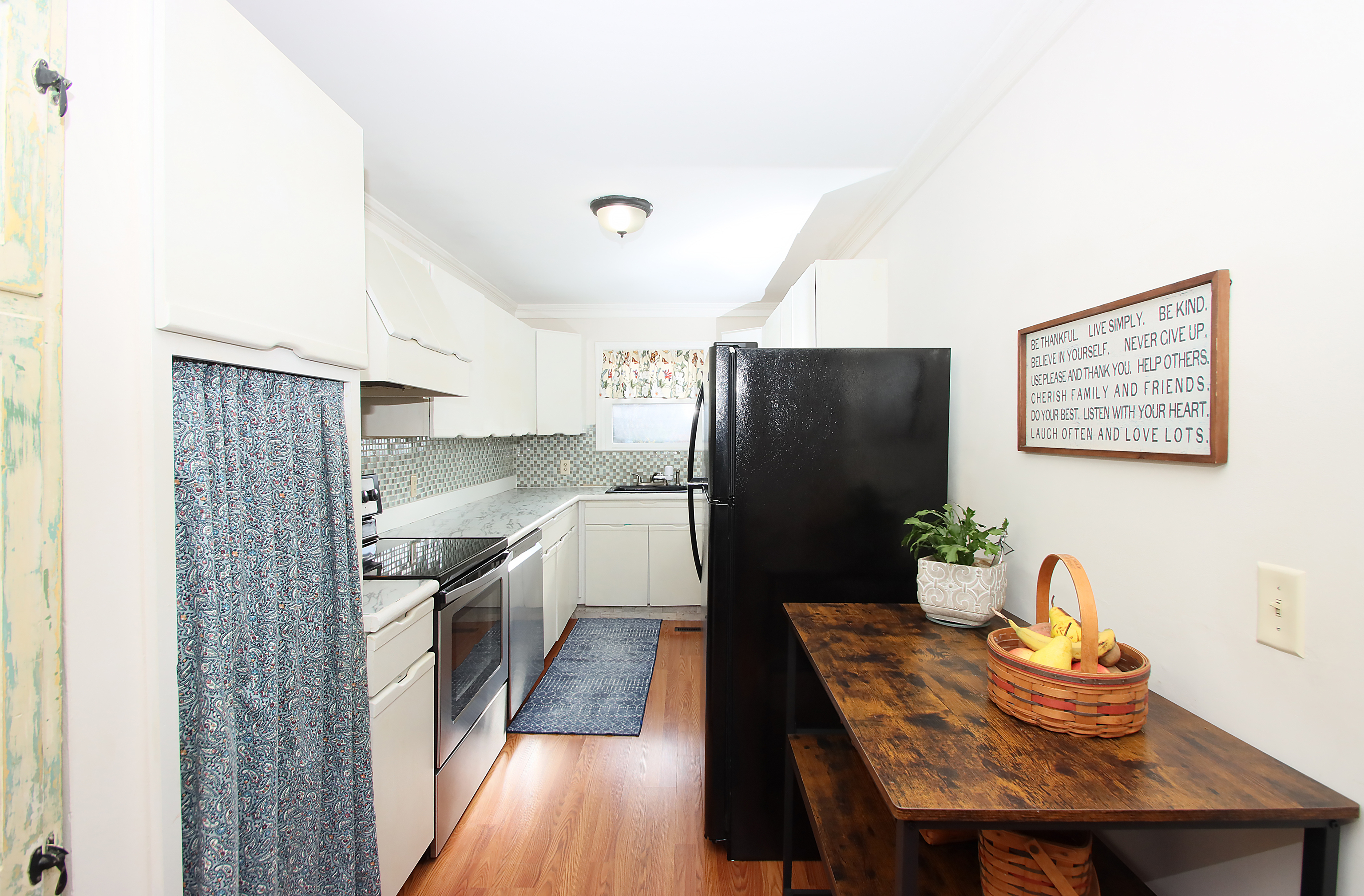 20 Carriage Drive Clinton, CT 06413 - Photo 8 of 31 a kitchen with stainless steel appliances granite countertop a refrigerator a sink dishwasher a dining table and chairs with wooden floor