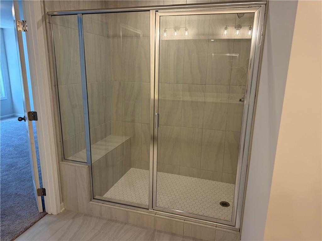 5151 Longview Run Decatur, GA 30035 - Photo 15 of 16 a bathroom with a glass shower door