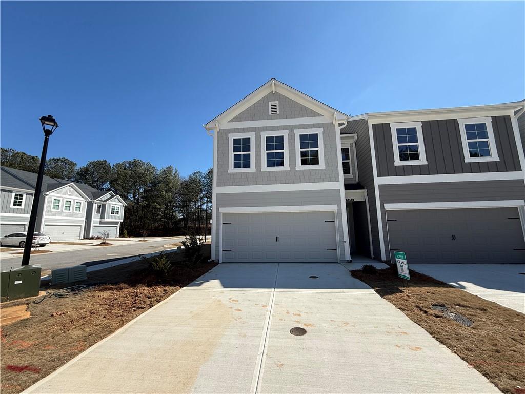 5151 Longview Run Decatur, GA 30035 - Photo 2 of 16 a front view of a house with a yard and garage