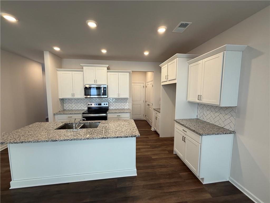 5151 Longview Run Decatur, GA 30035 - Photo 6 of 16 a large kitchen with stainless steel appliances granite countertop a stove a sink and a refrigerator