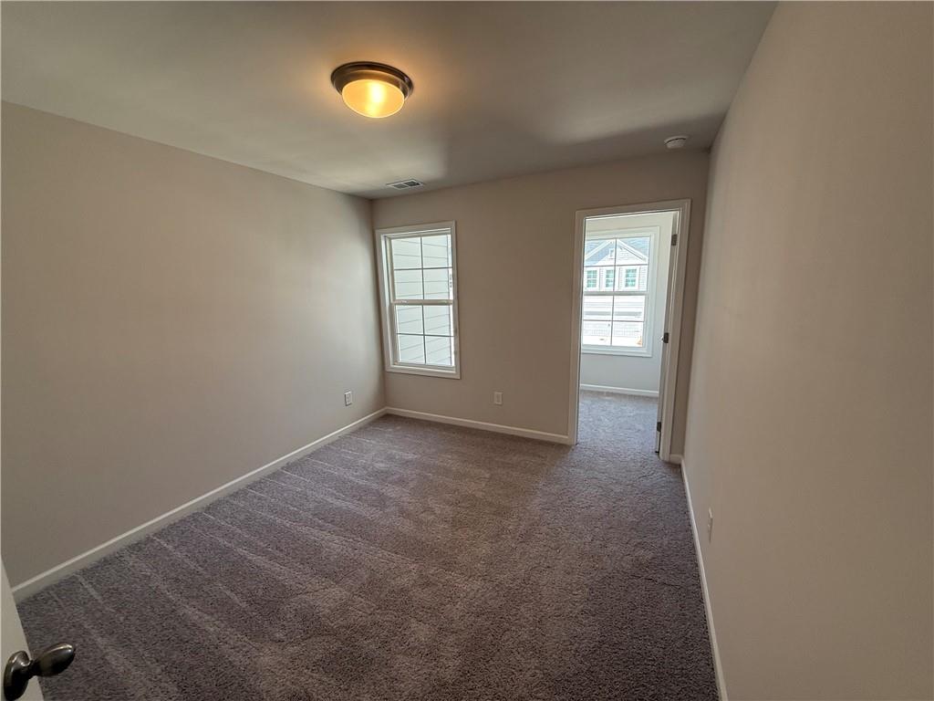 5151 Longview Run Decatur, GA 30035 - Photo 10 of 16 an empty room with windows and closet