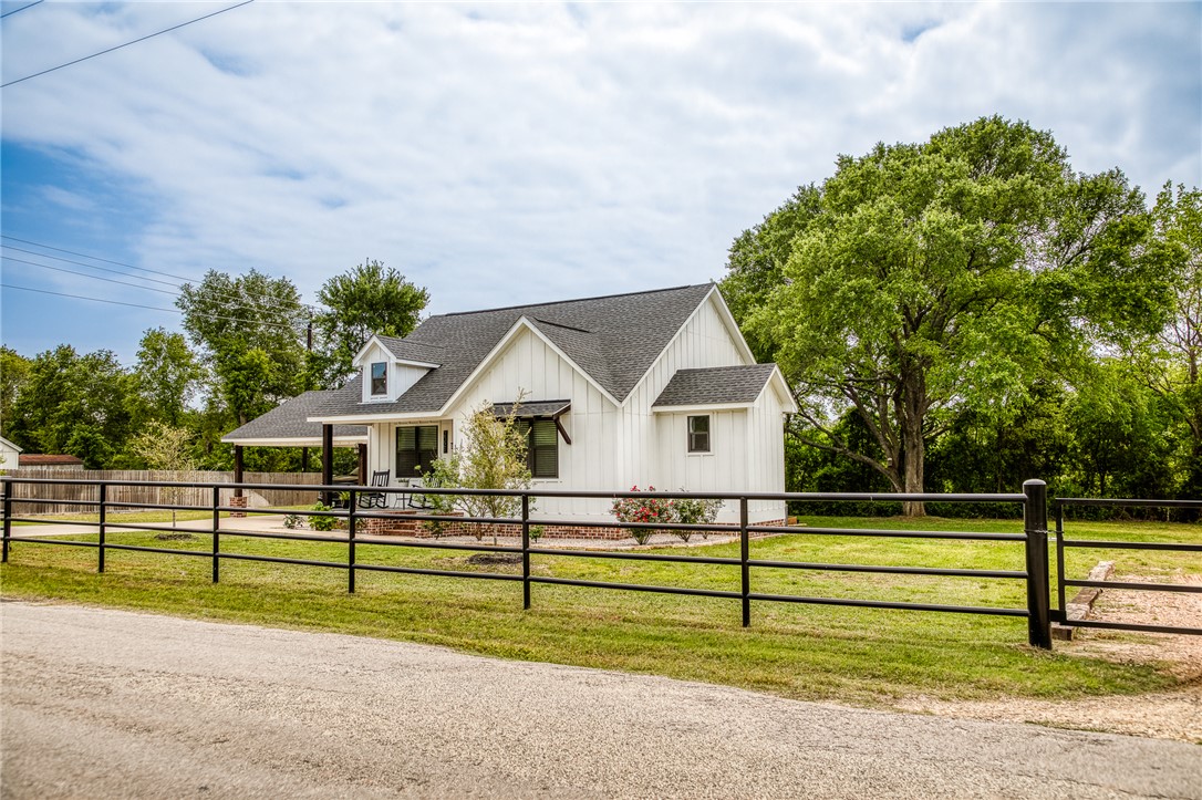 a view of a house in front of a big yard