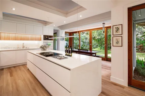 a view of swimming pool with outdoor seating and trees in the background