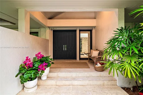 a kitchen with a stove a sink and a refrigerator with wooden floor