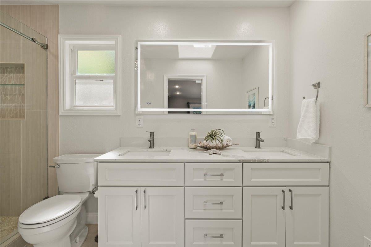 25400 Radonich Road Los Gatos, CA 95033 - Photo 13 of 42 a bathroom with a toilet sink and mirror