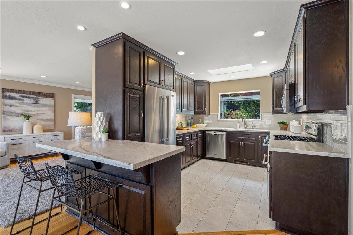 25400 Radonich Road Los Gatos, CA 95033 - Photo 9 of 42 a kitchen with granite countertop a sink appliances cabinets and furniture