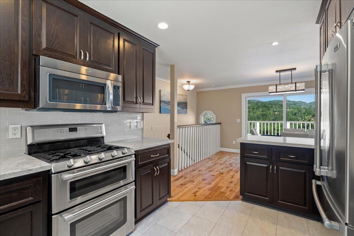 25400 Radonich Road Los Gatos, CA 95033 - Photo 10 of 42 a kitchen with wooden cabinets and a stove top oven