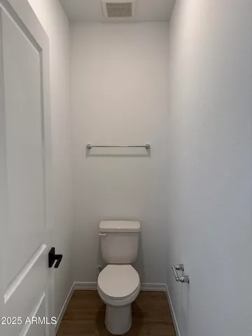 a white toilet sitting in a bathroom