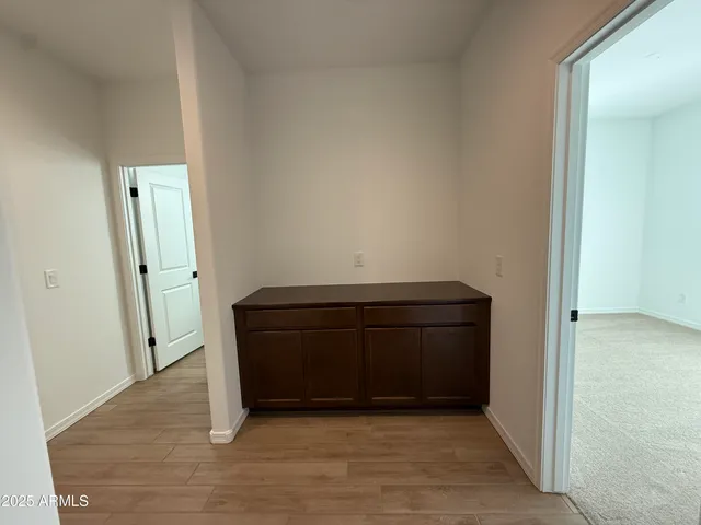 an empty room with wooden floor