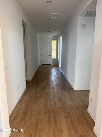 a view of a room with wooden floor and windows