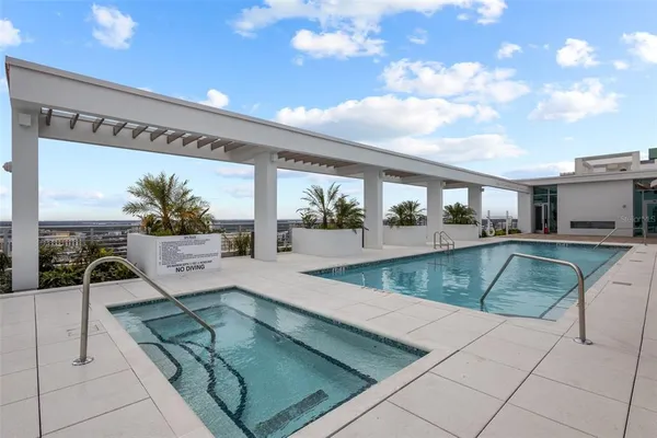a view of a swimming pool with a lounge chairs