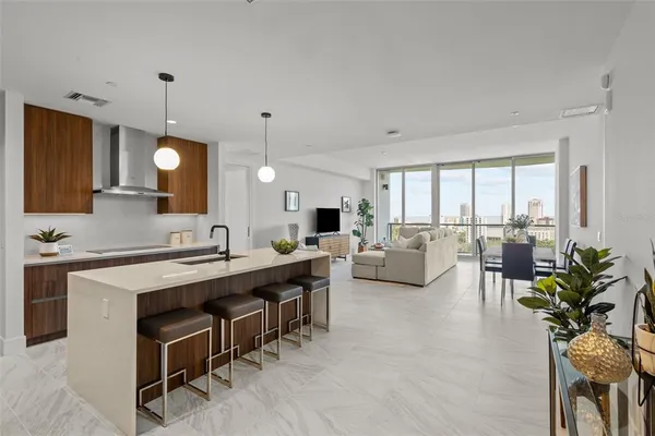 a living room with furniture a large window and appliances