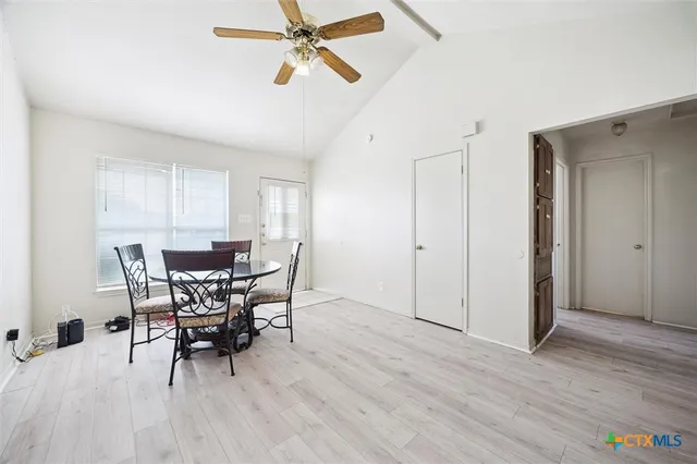 a view of a dining room with furniture and wooden floor