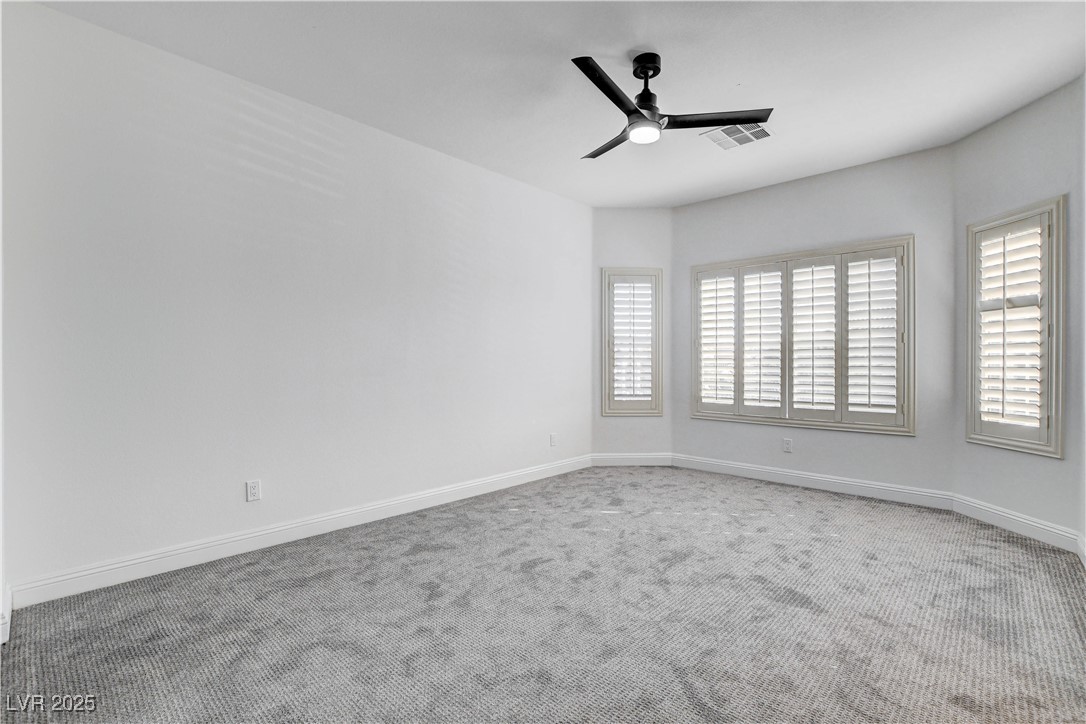 5148 Villa Vecchio Court Las Vegas, NV 89141 - Photo 58 of 71 Carpeted empty room featuring visible vents, baseboards, and ceiling fan