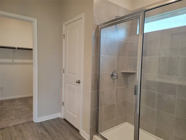 a bathroom with a glass shower door
