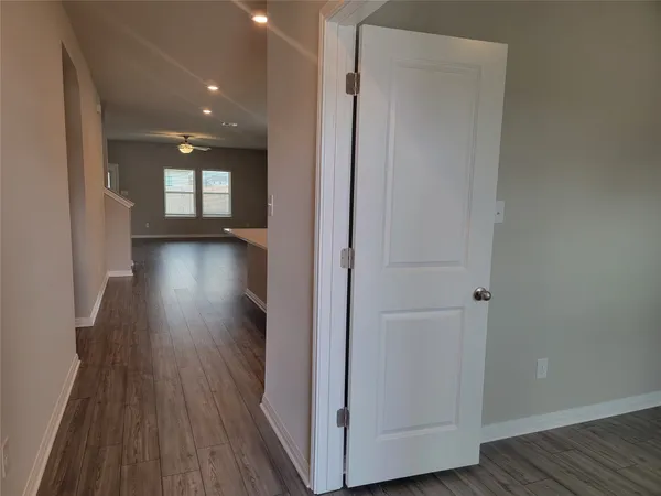 a view of hallway with wooden floor