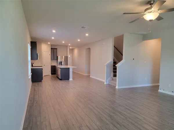 a view of a kitchen with a sink and a refrigerator