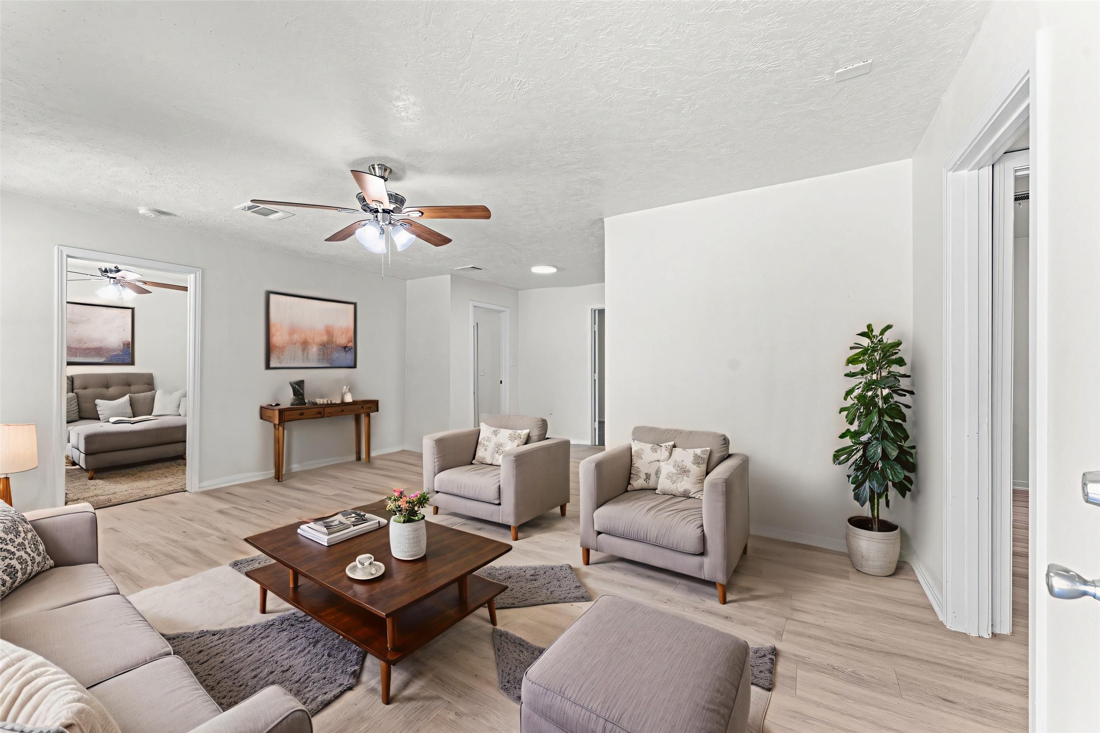 a living room with furniture and a potted plant