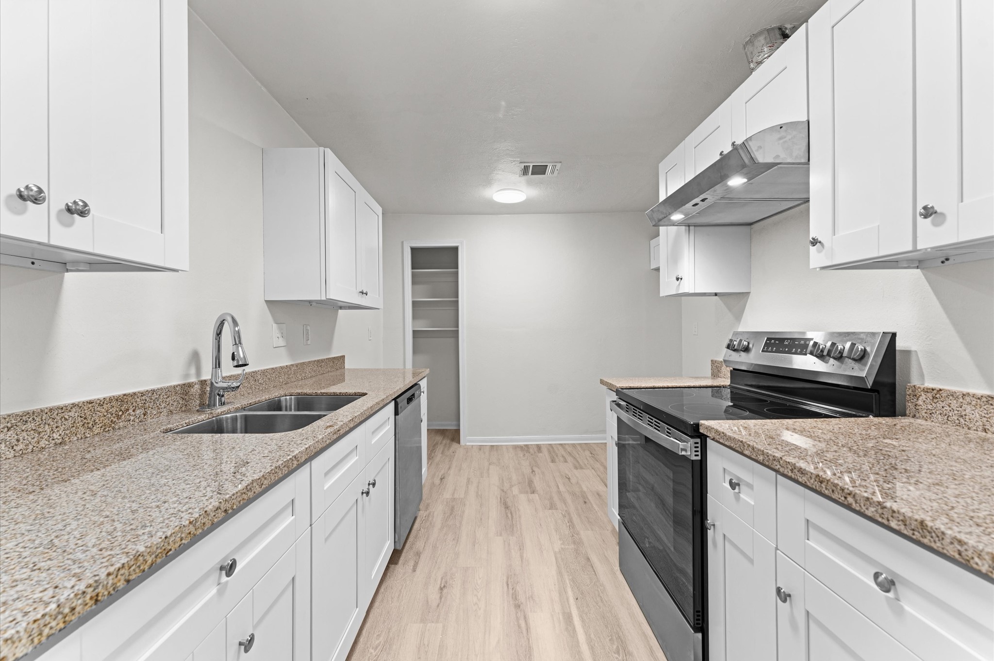 6515 Beekman Road Houston, TX 77021 - Photo 11 of 30 a kitchen with granite countertop stainless steel appliances a sink stove top oven and cabinets