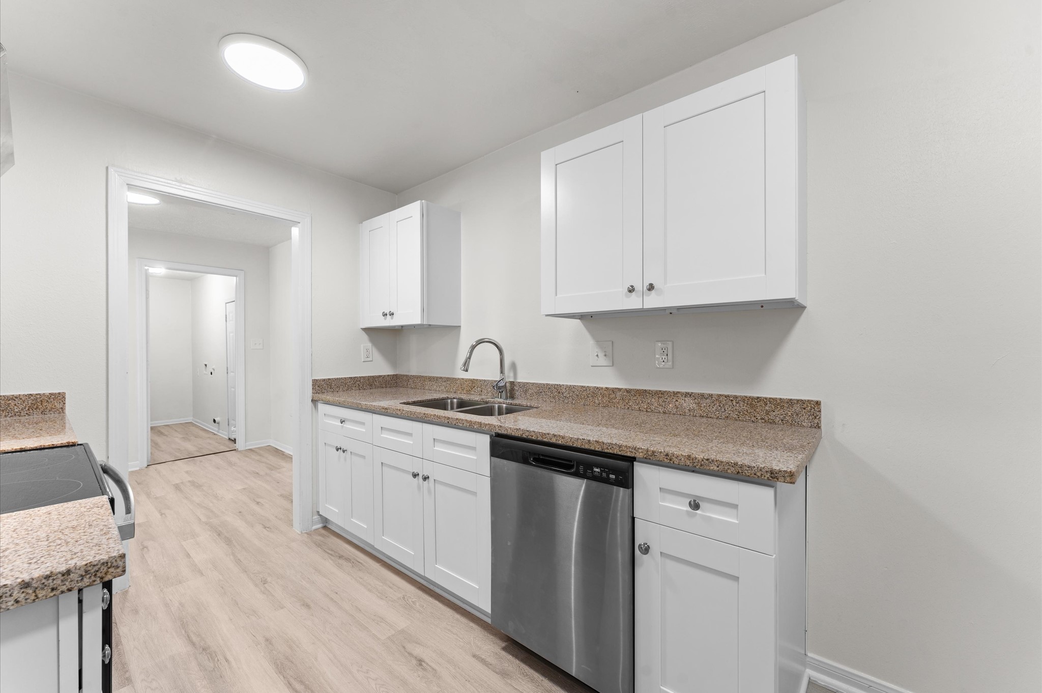 6515 Beekman Road Houston, TX 77021 - Photo 12 of 30 a kitchen with granite countertop white cabinets and a sink