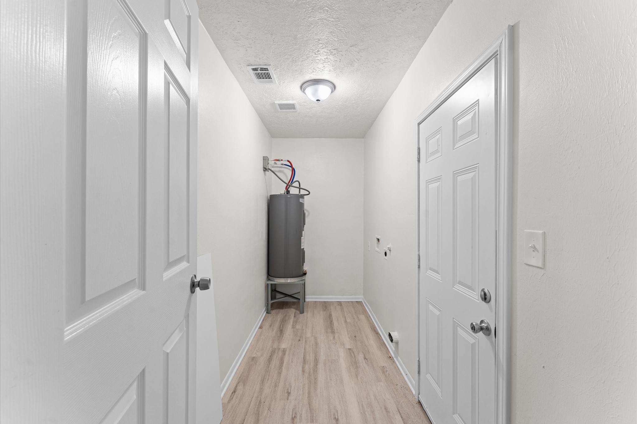 6515 Beekman Road Houston, TX 77021 - Photo 26 of 30 a view of a hallway with wooden floor and staircase