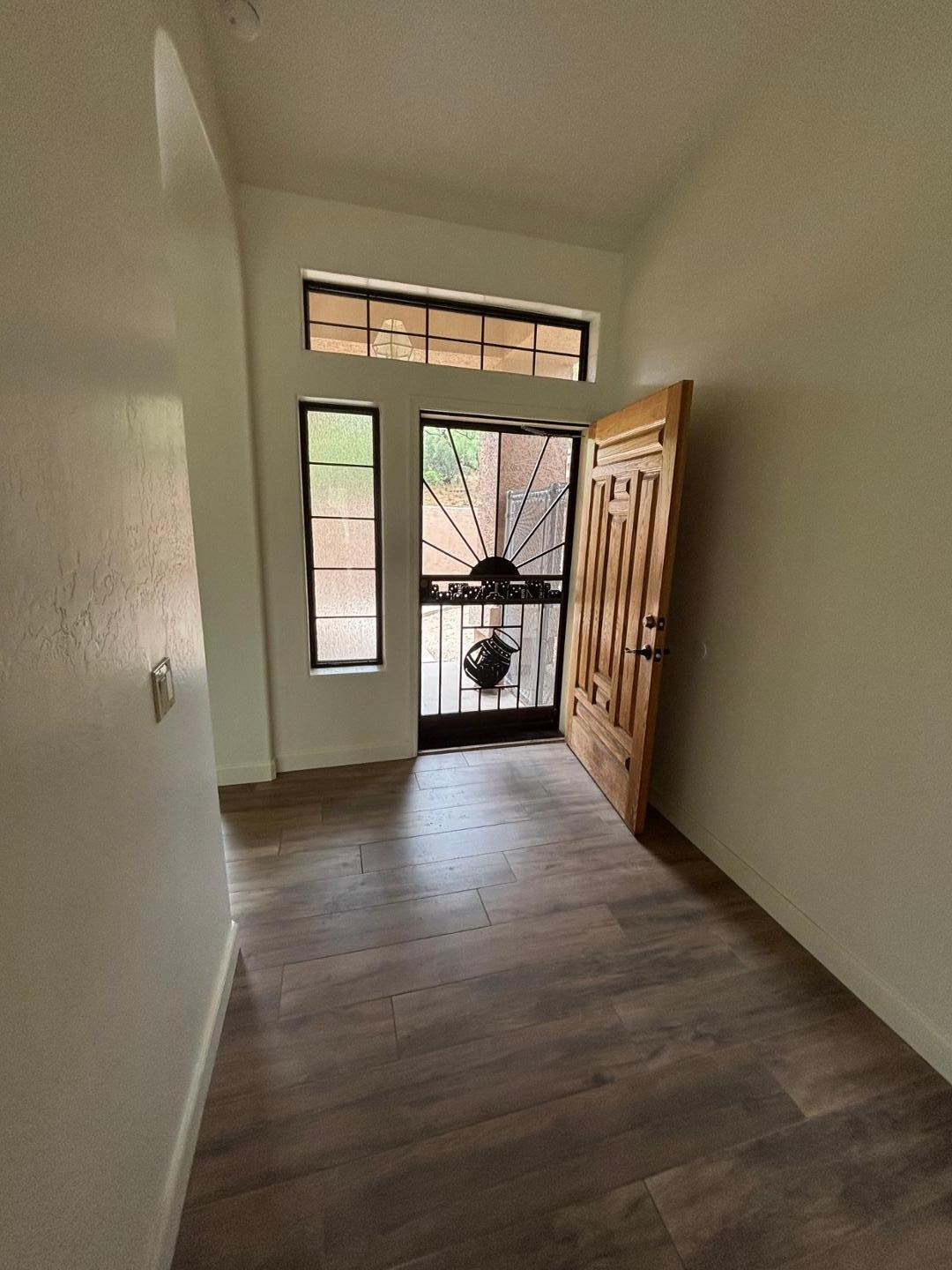 43003 North Old Mine Road Scottsdale, AZ 85262 - Photo 16 of 33 an empty room with wooden floor and windows