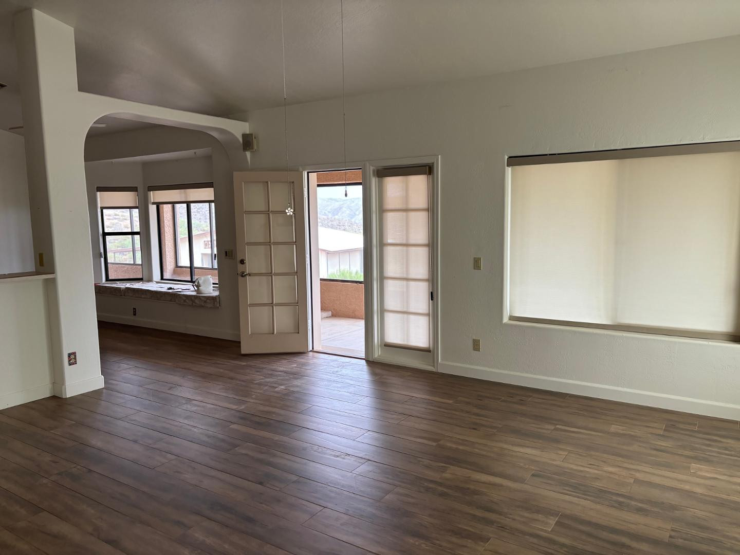 43003 North Old Mine Road Scottsdale, AZ 85262 - Photo 17 of 33 an empty room with wooden floor and windows