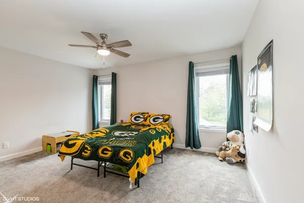 a bedroom with a bed and a chandelier