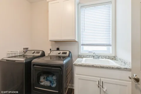 a bathroom with a sink and a washing machine