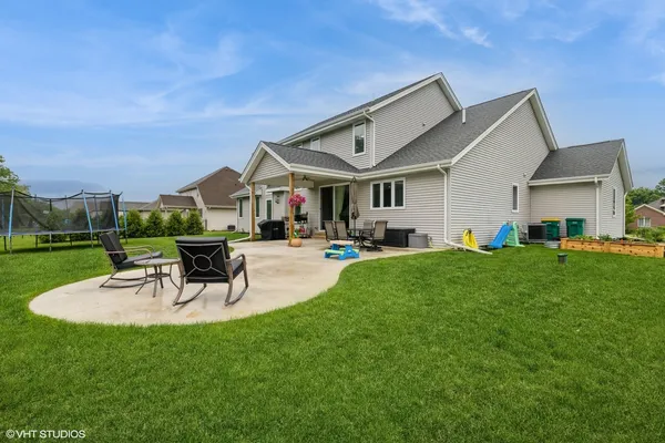 a view of a patio with couches and a table and chairs with garden