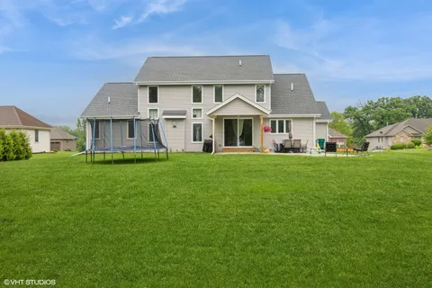 a front view of a house with a yard and trees