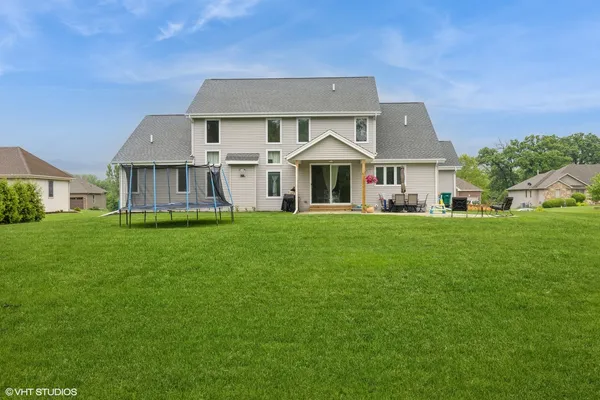 a front view of a house with a yard and trees
