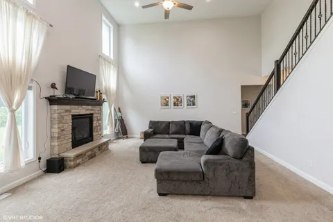 a living room with furniture a flat screen tv and a fireplace