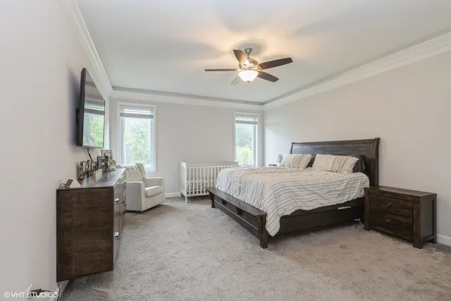 a spacious bedroom with a bed and a chandelier
