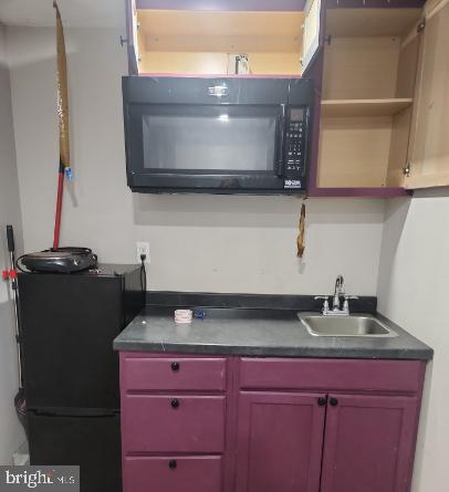 9349 Valley Road, Unit 101 Berkeley Springs, WV 25411 - Photo 3 of 5 a kitchen with a sink and a microwave