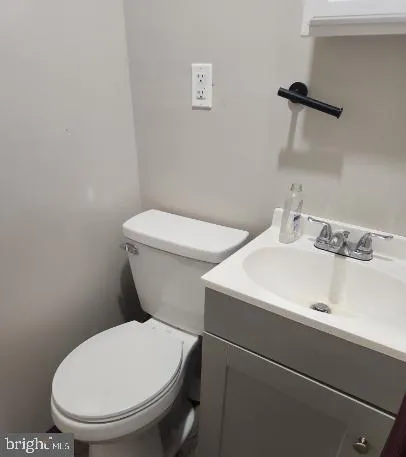 a white toilet sitting next to a bathroom sink