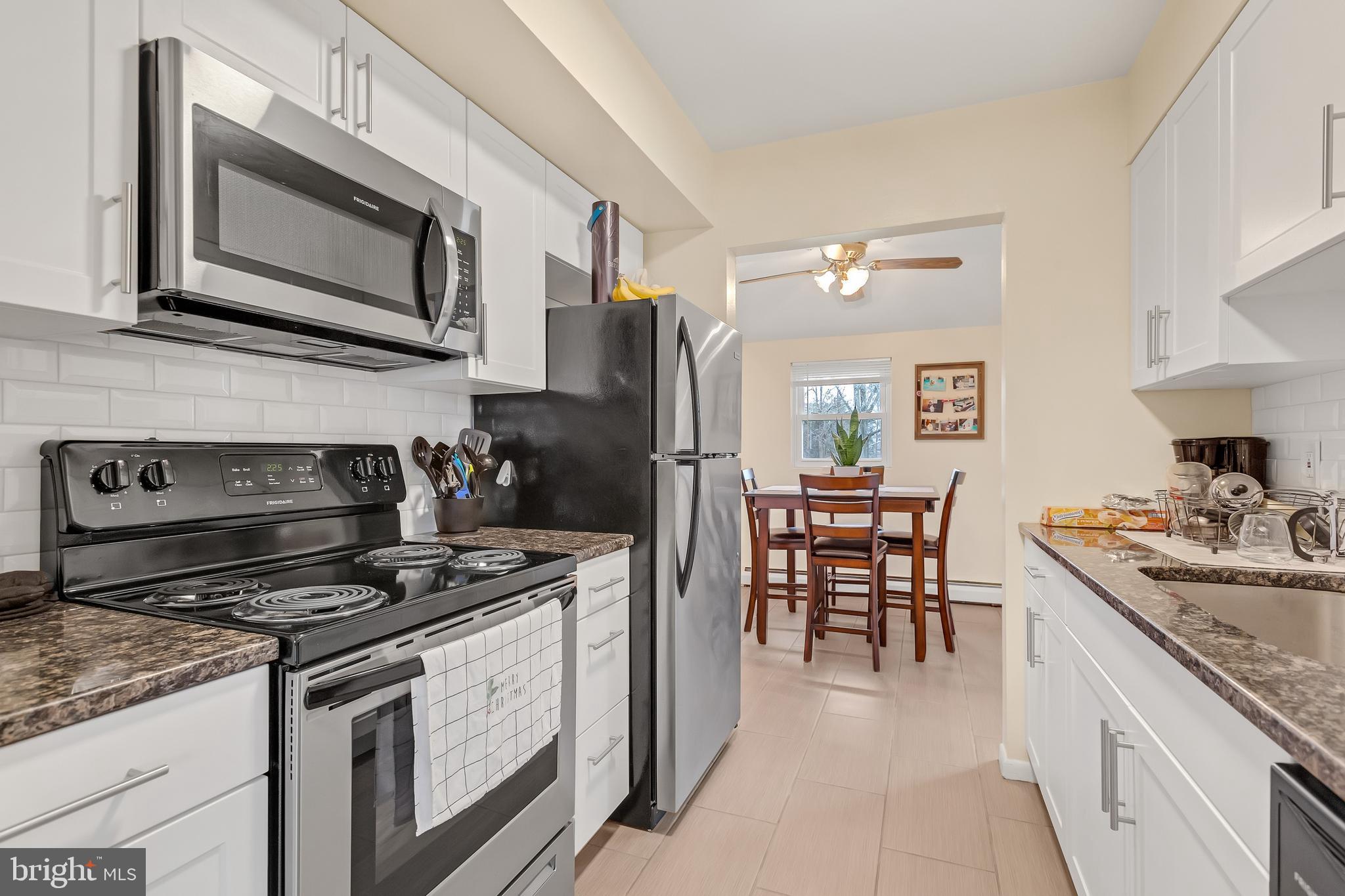 a kitchen with a stove cabinets and microwave