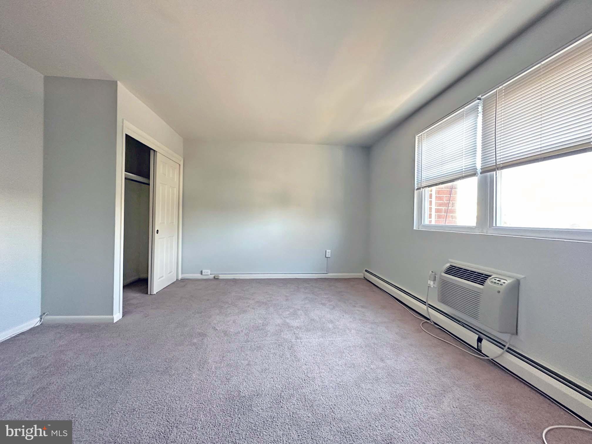 200 Spruce Street, Unit C11 Doylestown, PA 18901 - Photo 7 of 9 an empty room with windows and closet