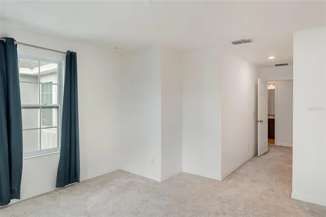 a view of an empty room and a window