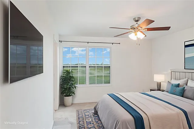 a bedroom with a large bed and a window