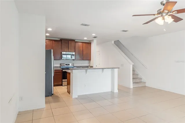 a view of kitchen with microwave and cabinets