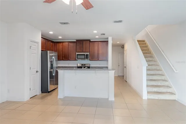 a kitchen with cabinets and refrigerator