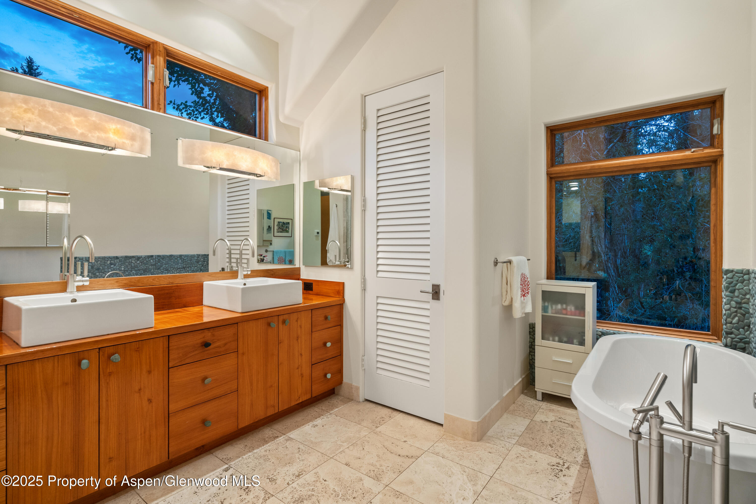 256 Twining Flats Road Aspen, CO 81611 - Photo 16 of 38 a spacious bathroom with a double vanity sink a mirror and a shower