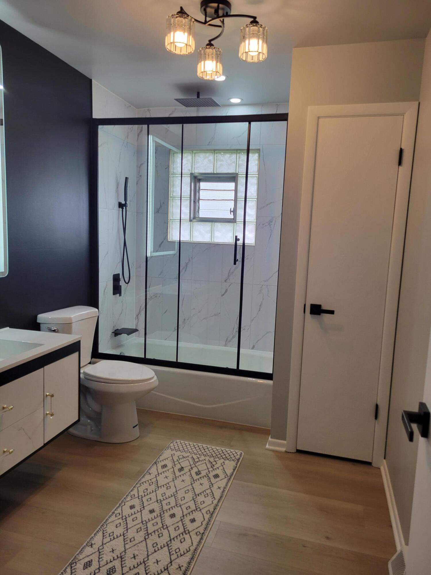 939 Devonshire Lane Dyer, IN 46311 - Photo 18 of 25 a bathroom with a toilet a sink a mirror and shower