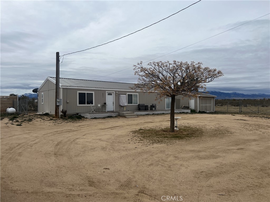 6951 Luna Road Phelan, CA 92371 - Photo 1 of 1 a front view of a house with garden