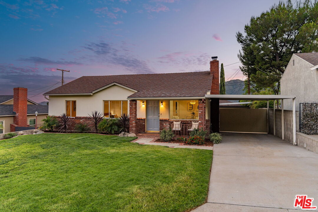 a view of a house with sitting area and garden