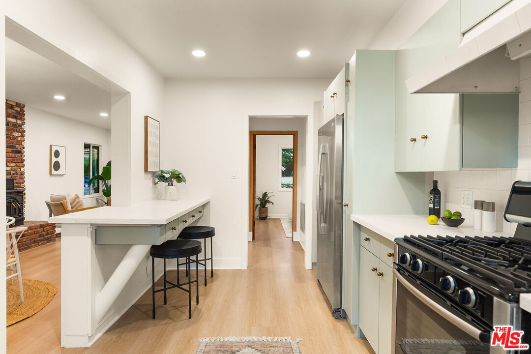 3330 Paraiso Way La Crescenta, CA 91214 - Photo 14 of 38 a kitchen with stainless steel appliances kitchen island granite countertop a stove a sink and a refrigerator