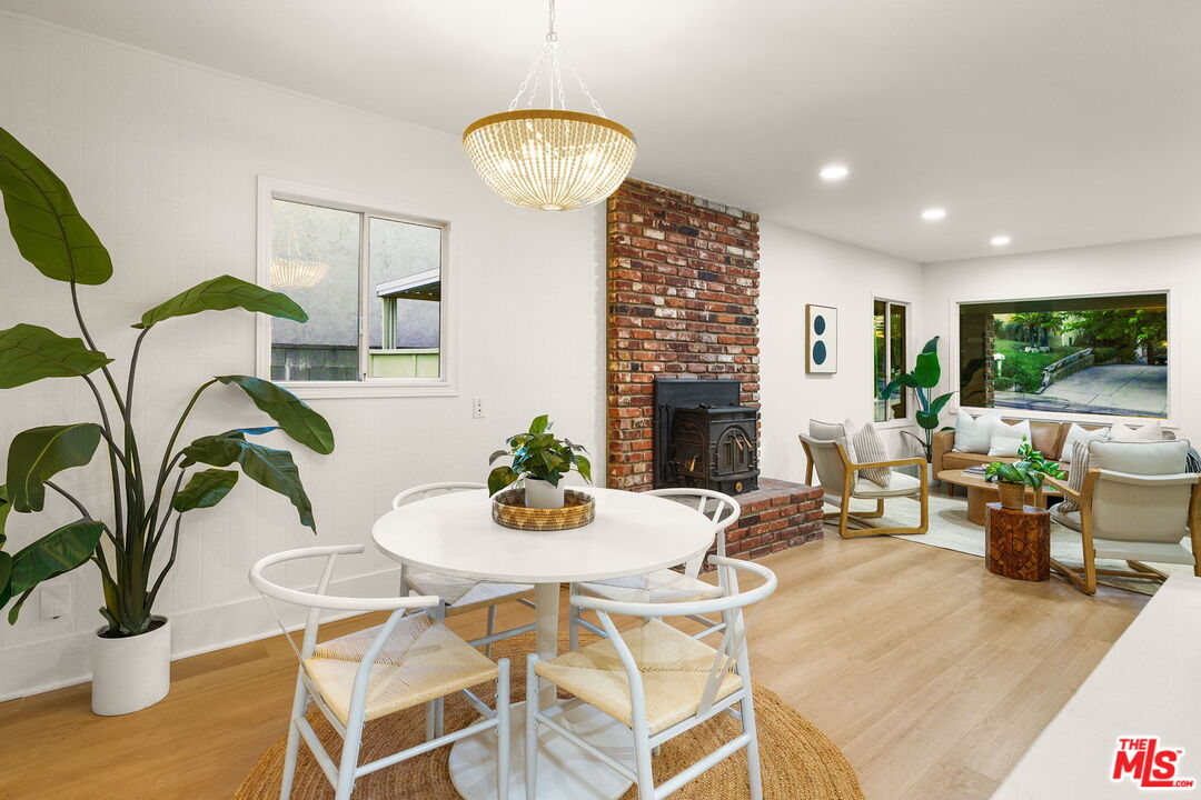 3330 Paraiso Way La Crescenta, CA 91214 - Photo 8 of 38 a living room with fireplace furniture dining table and a fireplace