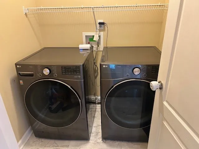 a white toilet sitting next to a bath tub
